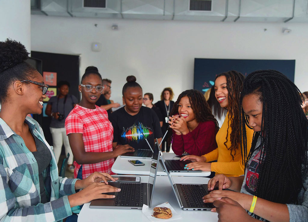 People using the Made With Code site at an event